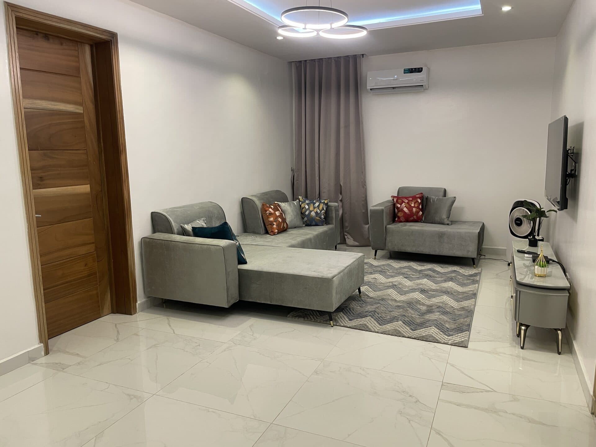 Spotless living room with grey sofas and polished marble floor after an Etanaya clean