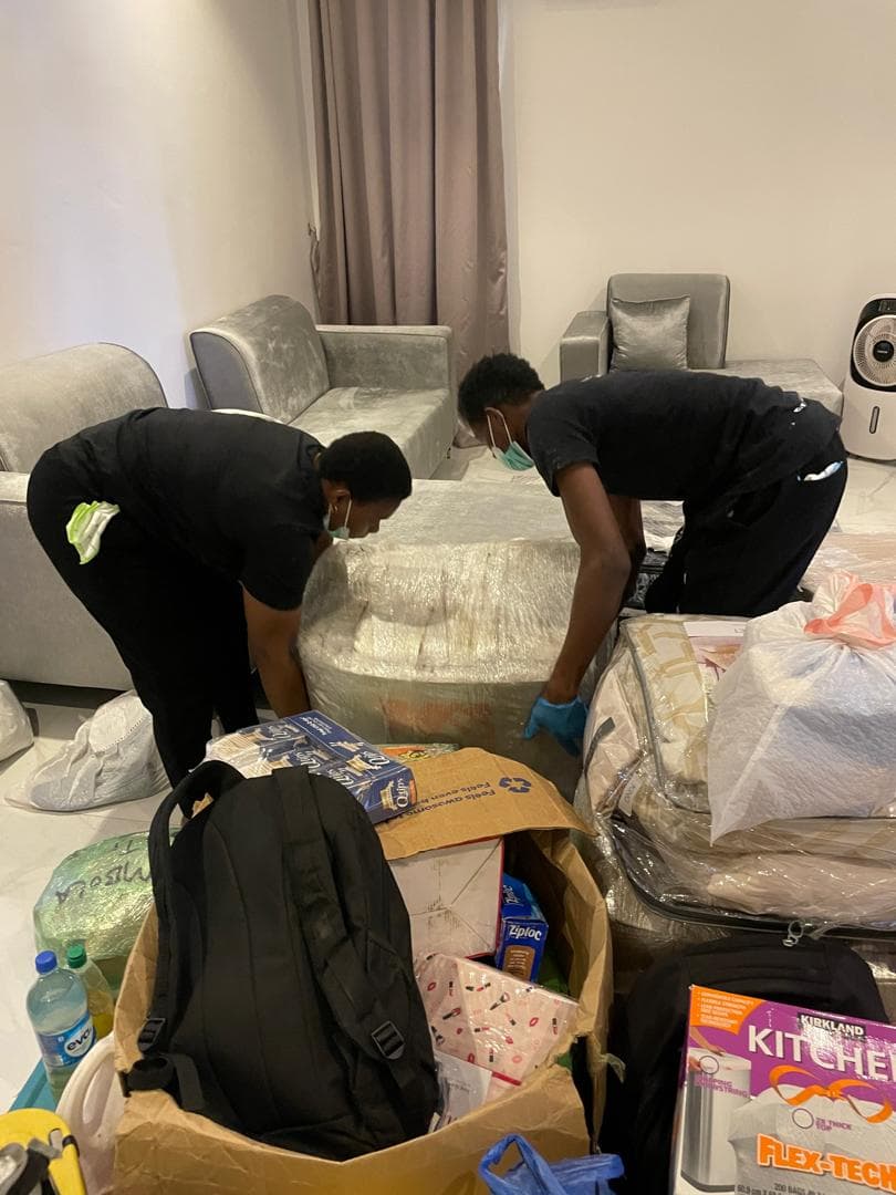 Two Etanaya staff wrapping and protecting furniture during a move-in preparation clean