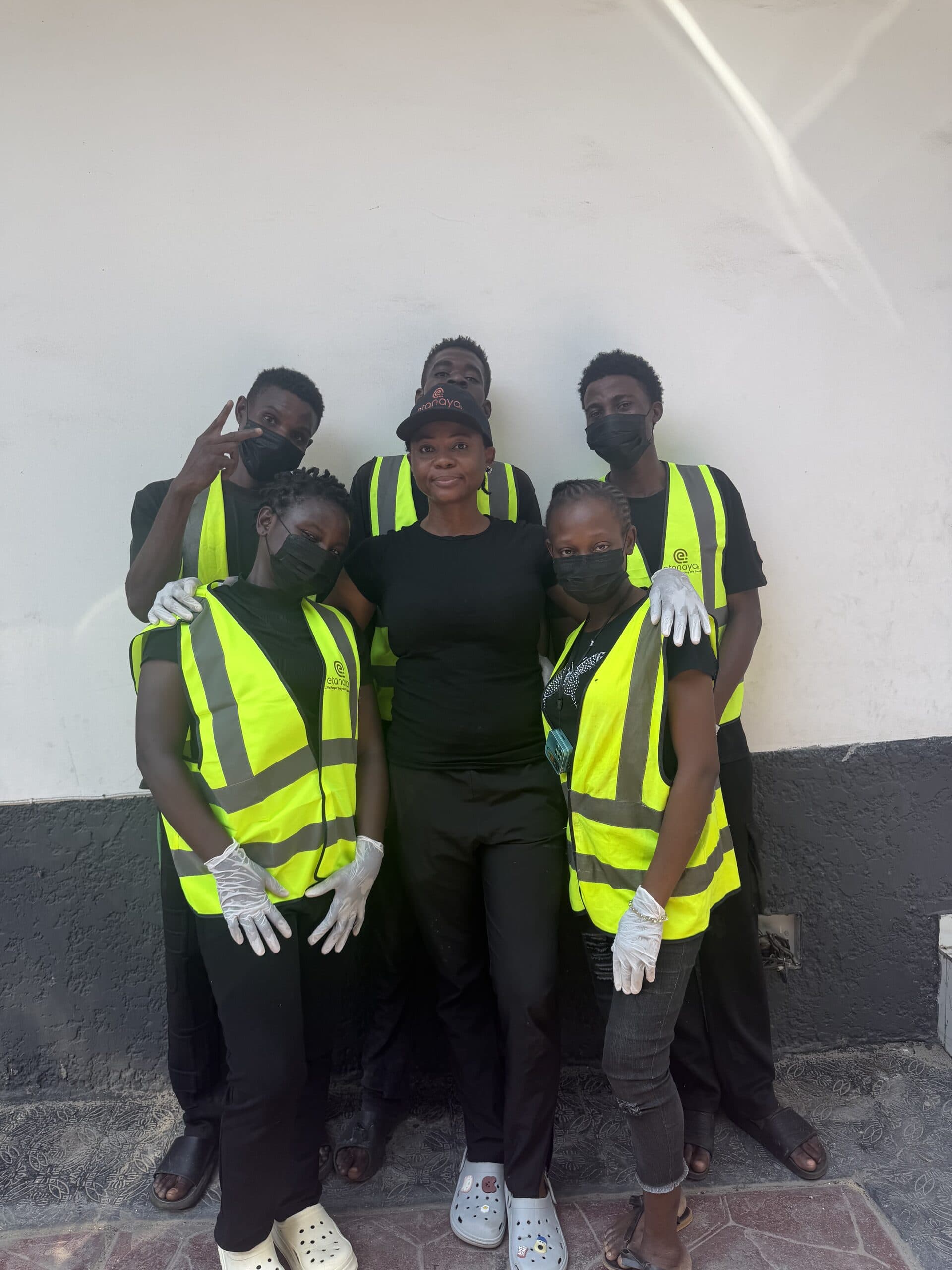 Etanaya cleaning team in branded hi-vis vests and gloves, standing together on site